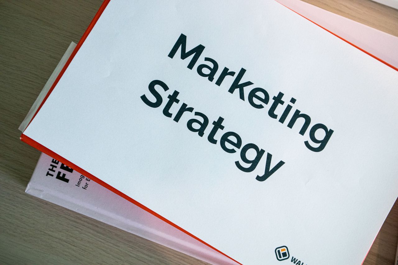 Services-02 A marketing strategy document displayed on a desk, showcasing business planning essentials.
